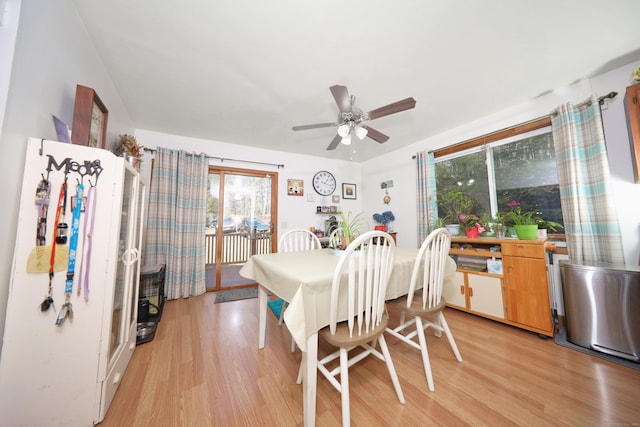 dining space featuring a ceiling fan and light wood finished floors