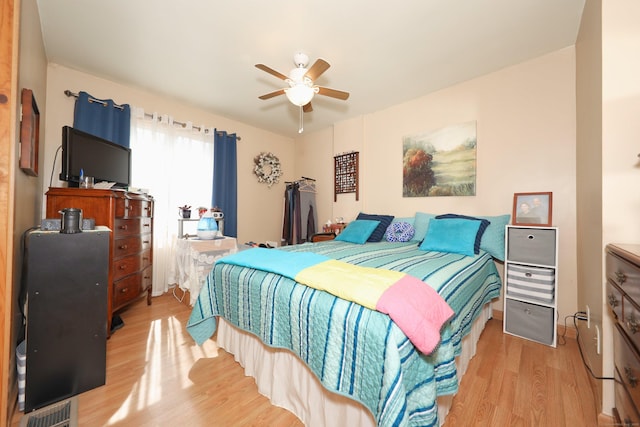 bedroom featuring visible vents, a ceiling fan, and wood finished floors