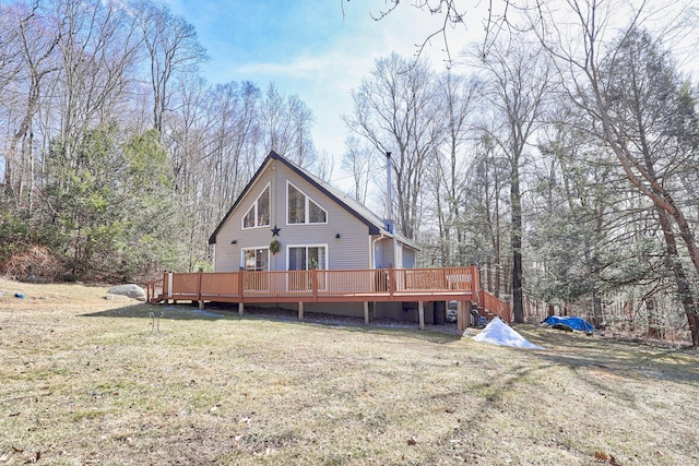 rear view of property featuring a yard and a wooden deck