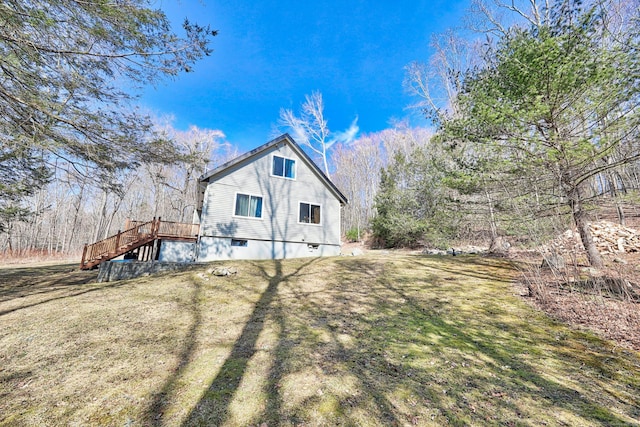 view of side of property with a lawn and stairs