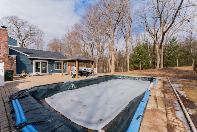 view of pool featuring a covered pool, a gazebo, and a patio