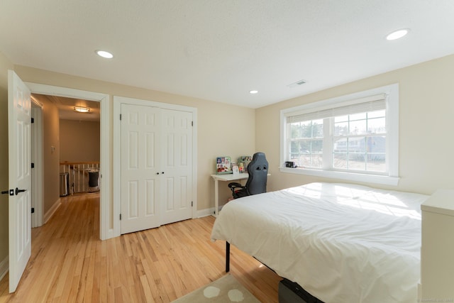 bedroom featuring recessed lighting, light wood-type flooring, baseboards, and visible vents