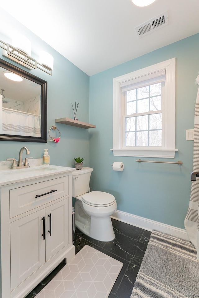 bathroom featuring vanity, baseboards, visible vents, toilet, and marble finish floor