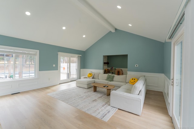 living area with light wood finished floors, visible vents, lofted ceiling with beams, wainscoting, and recessed lighting