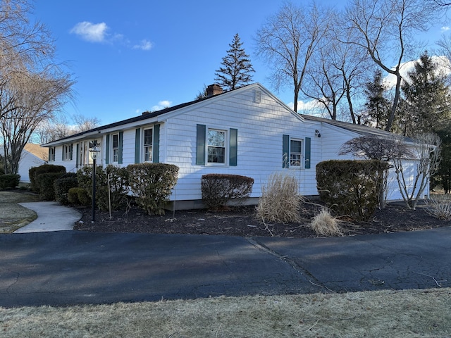 view of home's exterior featuring a chimney