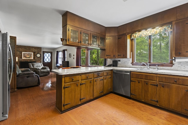 4 Wildwood Ln, Weston, CT 06883 - kitchen with stainless steel appliances, a peninsula, a sink, open floor plan, and light wood finished floors
