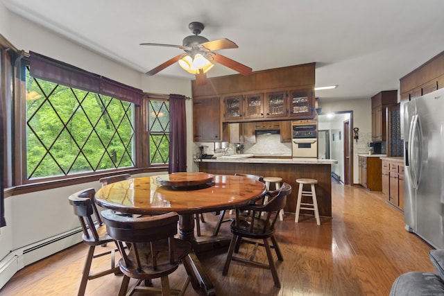4 Wildwood Ln, Weston, CT 06883 - dining space featuring light wood finished floors, a ceiling fan, and baseboard heating
