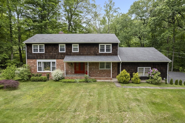 4 Wildwood Ln, Weston, CT 06883 - view of front of house with a front lawn, roof with shingles, covered porch, and brick siding