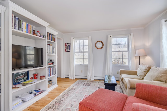 living area with light wood-style flooring and ornamental molding