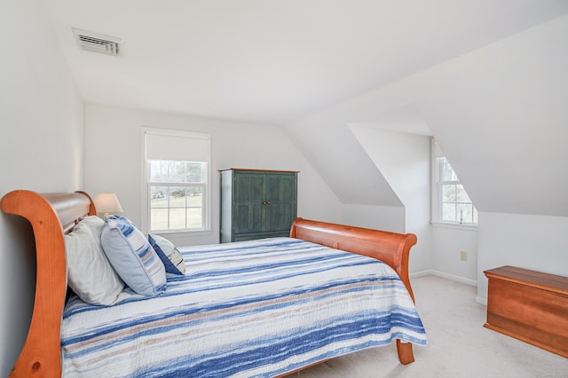 bedroom featuring vaulted ceiling, carpet flooring, baseboards, and visible vents