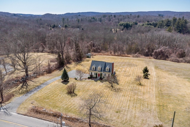 drone / aerial view with a wooded view