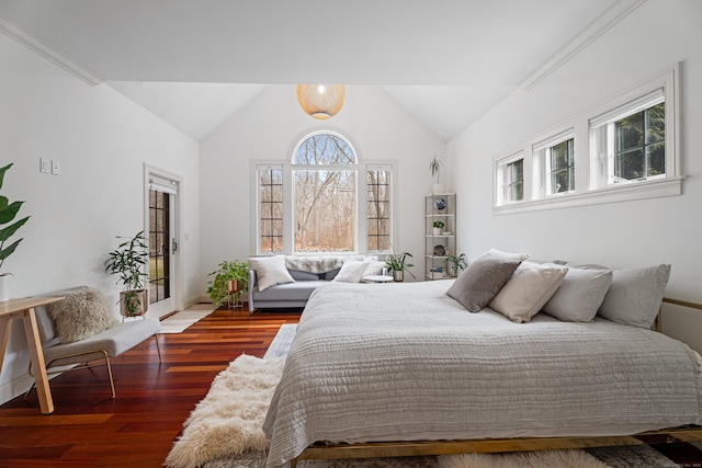 bedroom with lofted ceiling, baseboards, wood finished floors, and access to outside