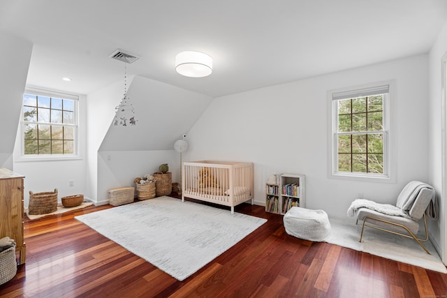 bedroom featuring dark wood-style flooring, visible vents, baseboards, and multiple windows