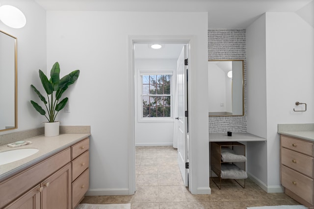 bathroom featuring tile patterned flooring, baseboards, and vanity
