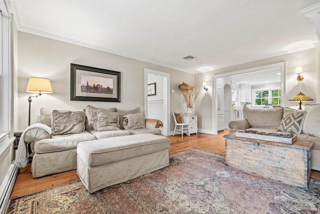 1 Hathaway Rd, East Lyme, CT 06333 - living area with baseboard heating, wood finished floors, and ornamental molding