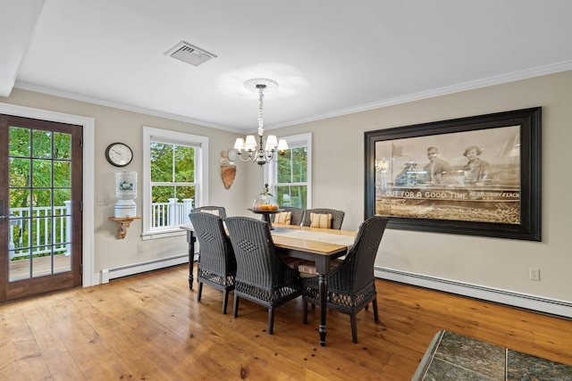 1 Hathaway Rd, East Lyme, CT 06333 - dining space featuring a baseboard heating unit, a chandelier, hardwood / wood-style flooring, crown molding, and healthy amount of natural light
