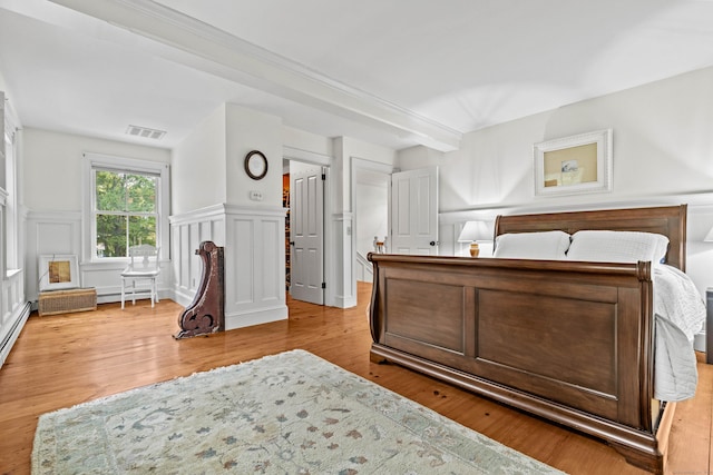 1 Hathaway Rd, East Lyme, CT 06333 - bedroom with a decorative wall, a baseboard radiator, wood finished floors, and a wainscoted wall