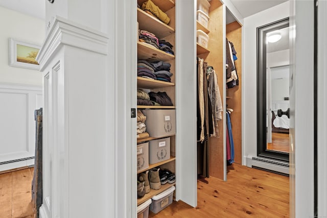 1 Hathaway Rd, East Lyme, CT 06333 - walk in closet featuring baseboard heating and light wood-style floors