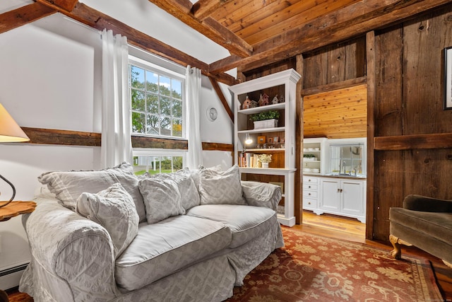 1 Hathaway Rd, East Lyme, CT 06333 - living area with wood finished floors, a wooden ceiling with exposed beams, a baseboard radiator, and wooden walls