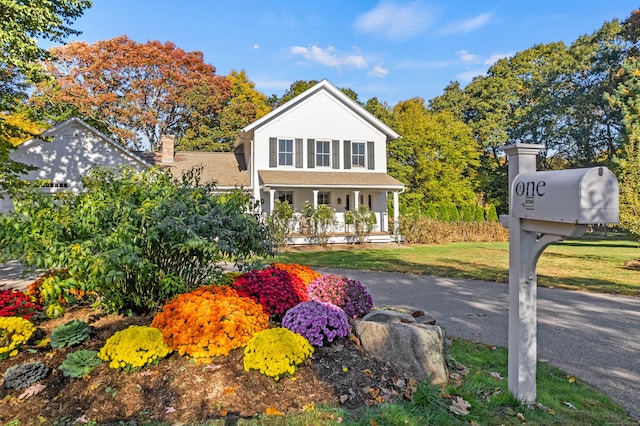 1 Hathaway Rd, East Lyme, CT 06333 - view of front of property with a porch, a chimney, and a front yard