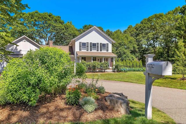1 Hathaway Rd, East Lyme, CT 06333 - view of front facade featuring a chimney, a front lawn, and covered porch