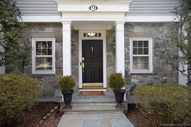 view of exterior entry featuring stone siding