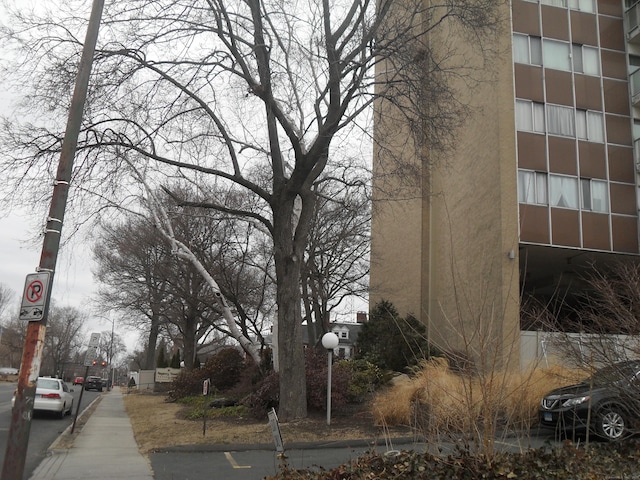 view of street with sidewalks, traffic signs, and curbs