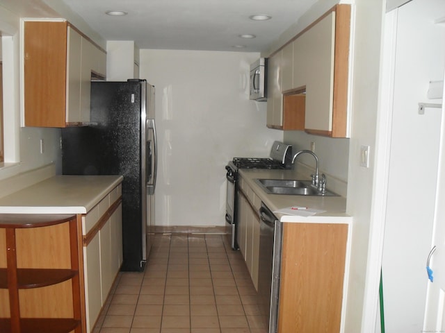 kitchen featuring light tile patterned floors, stainless steel appliances, recessed lighting, light countertops, and a sink