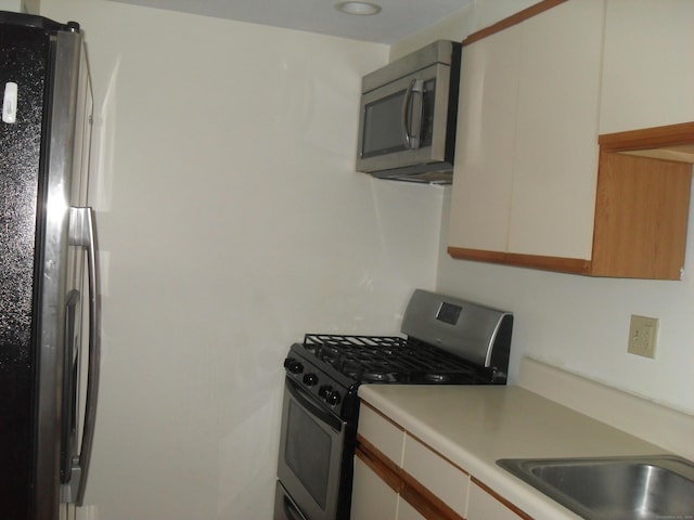 kitchen featuring stainless steel appliances and light countertops