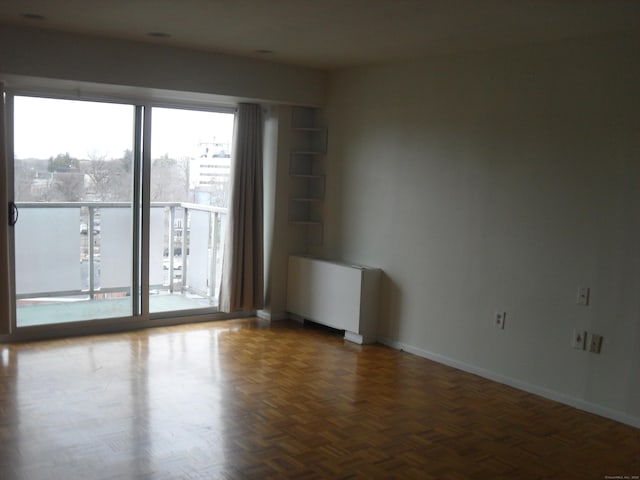 empty room with radiator and baseboards