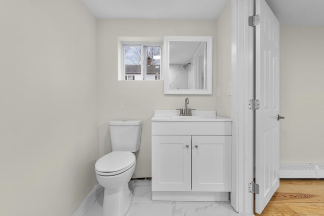 bathroom with toilet, marble finish floor, baseboard heating, and vanity