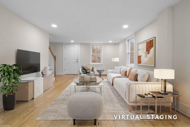 living area with stairs, light wood-type flooring, baseboards, and recessed lighting