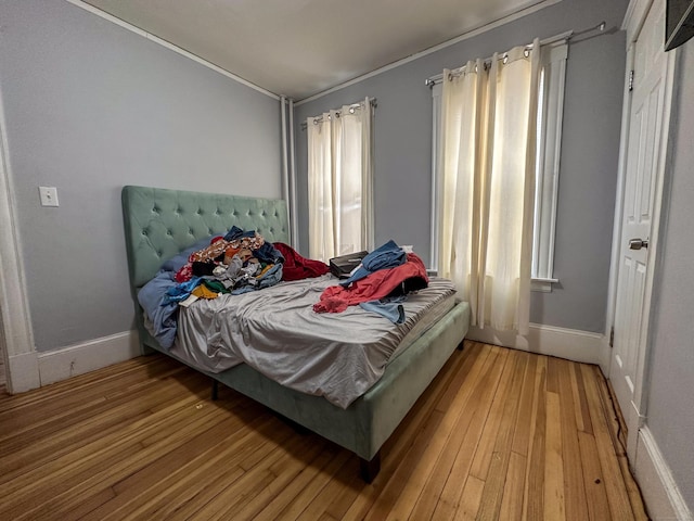 bedroom with light wood-type flooring and baseboards