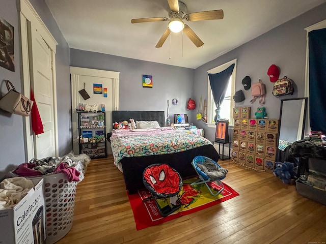 bedroom with a ceiling fan and wood-type flooring