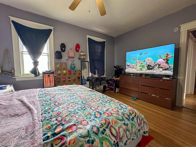 bedroom with a ceiling fan and wood finished floors