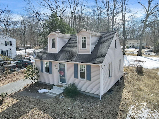 view of front of house featuring entry steps and a shingled roof