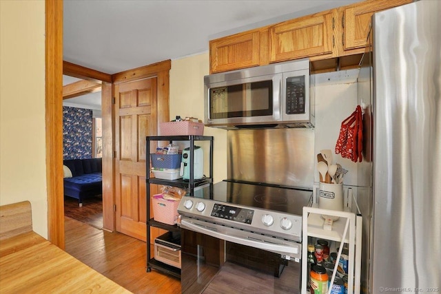 kitchen featuring stainless steel appliances and wood finished floors