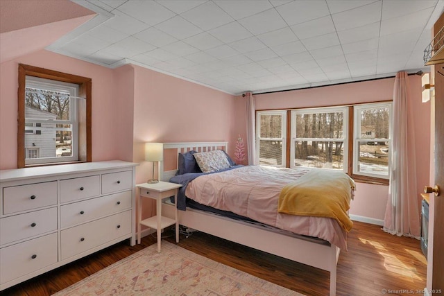 bedroom featuring baseboards and wood finished floors