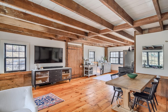 dining room featuring beamed ceiling, hardwood / wood-style floors, and wooden ceiling