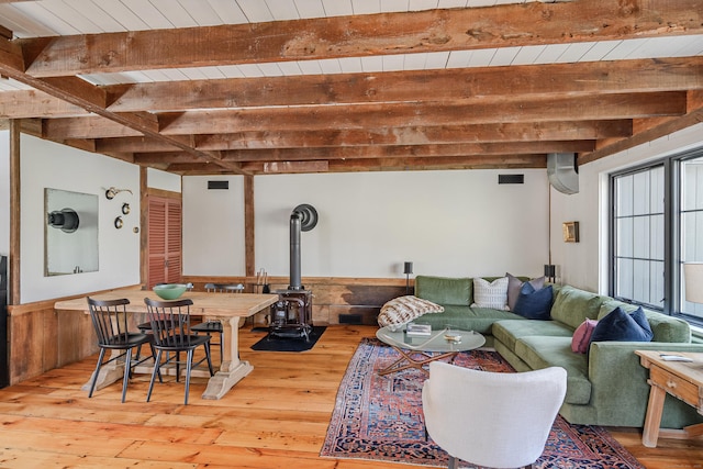 living room featuring visible vents, beamed ceiling, wooden ceiling, and wood-type flooring