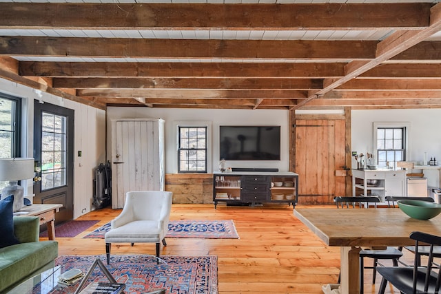 living area featuring beam ceiling and wood-type flooring