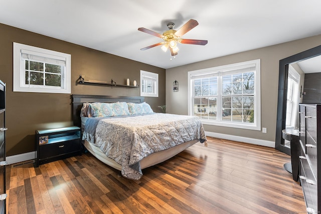 bedroom with wood finished floors, baseboards, and ceiling fan