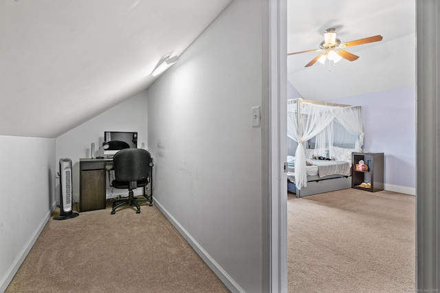 home office featuring baseboards, carpet floors, lofted ceiling, and a ceiling fan