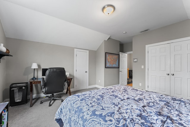 bedroom with carpet, visible vents, baseboards, vaulted ceiling, and a closet