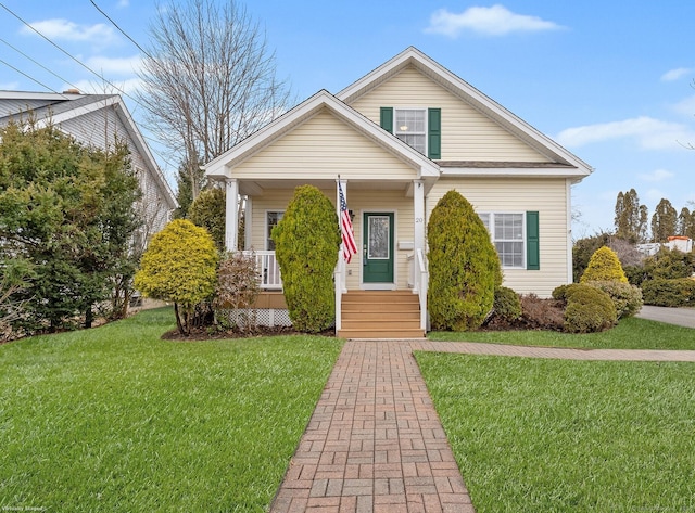 bungalow-style house with a front lawn and a porch