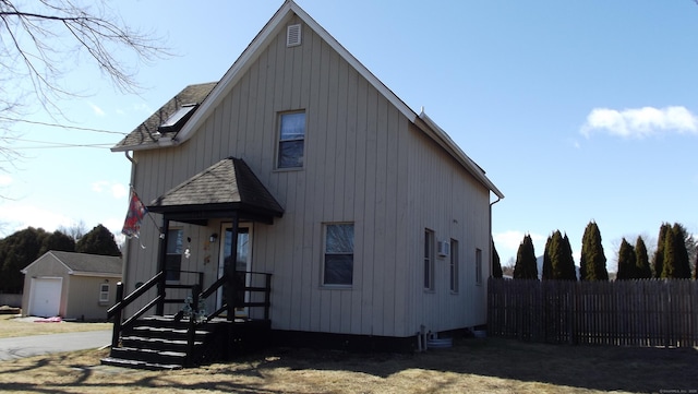 view of front of property with fence and roof with shingles