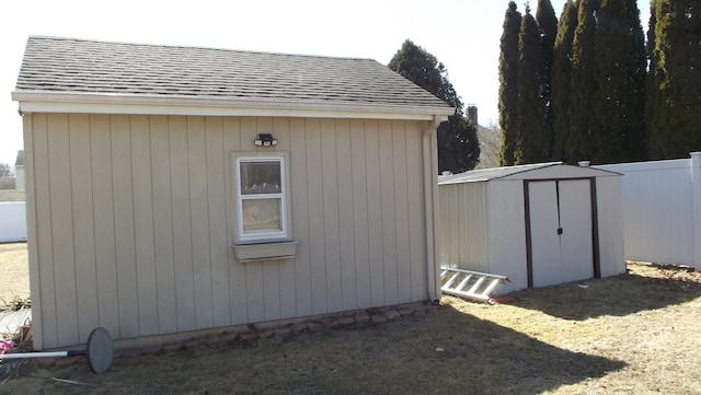 view of shed featuring fence