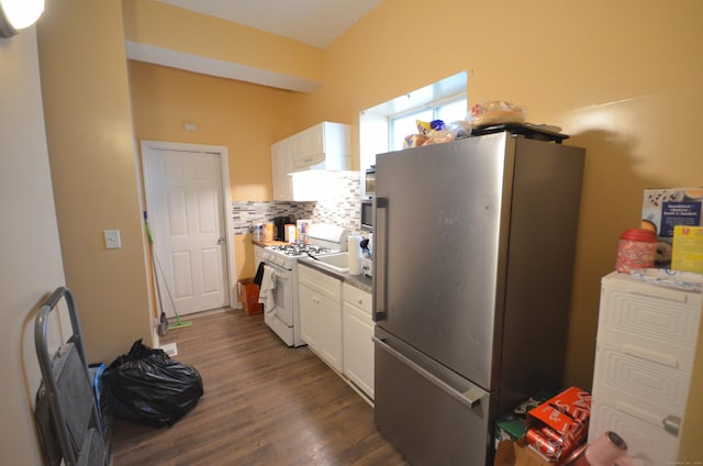 kitchen featuring backsplash, gas range gas stove, freestanding refrigerator, white cabinetry, and dark wood-style flooring