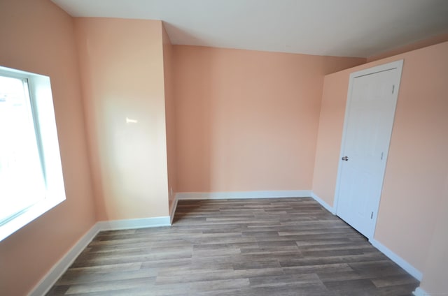 unfurnished room featuring baseboards and wood finished floors