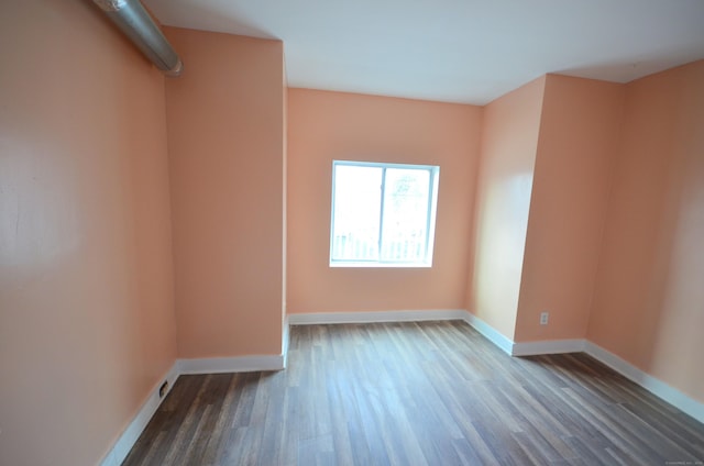 empty room with wood finished floors and baseboards